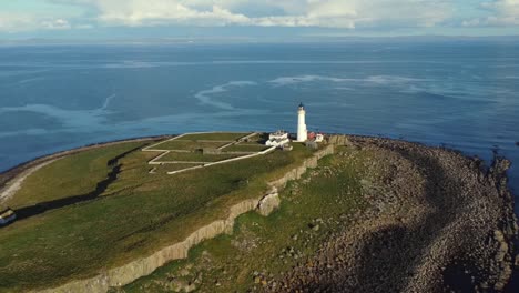 Aerial-view-of-Pladda-Lighthouse-on-the-Isle-of-Arran-on-a-sunny-day,-Scotland