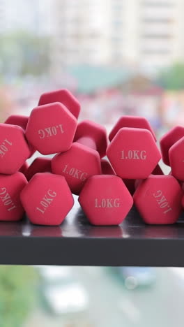 view of red dumbbells, gym. sport and healthy lifestyle concept