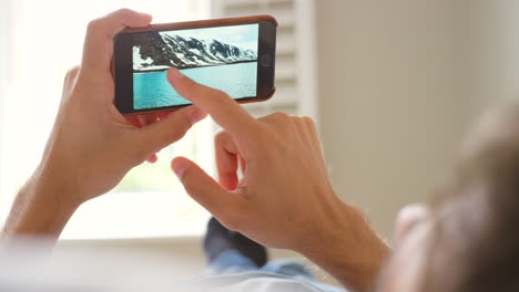 person looking at a photo on a smartphone