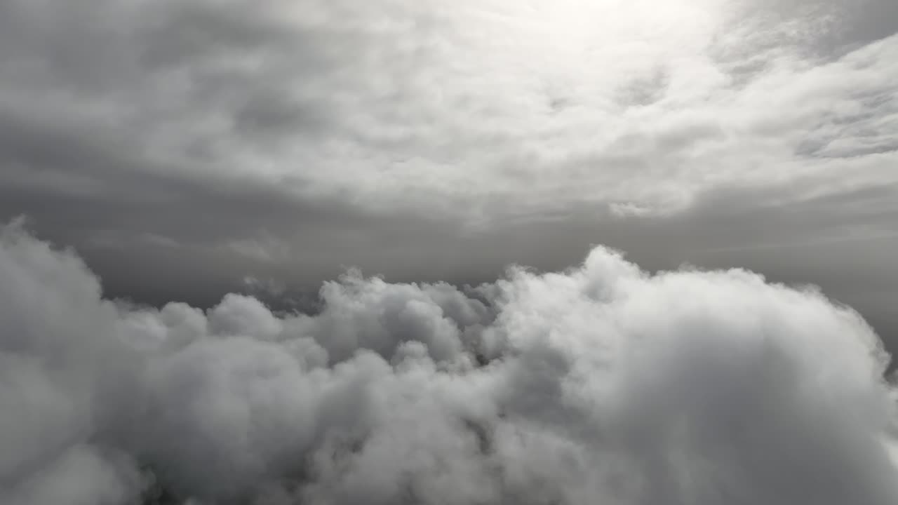 Aerial footage of clouds illuminated by the morning light