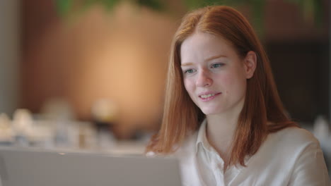 young woman in white shirt is communicating online with partners or employees from her office