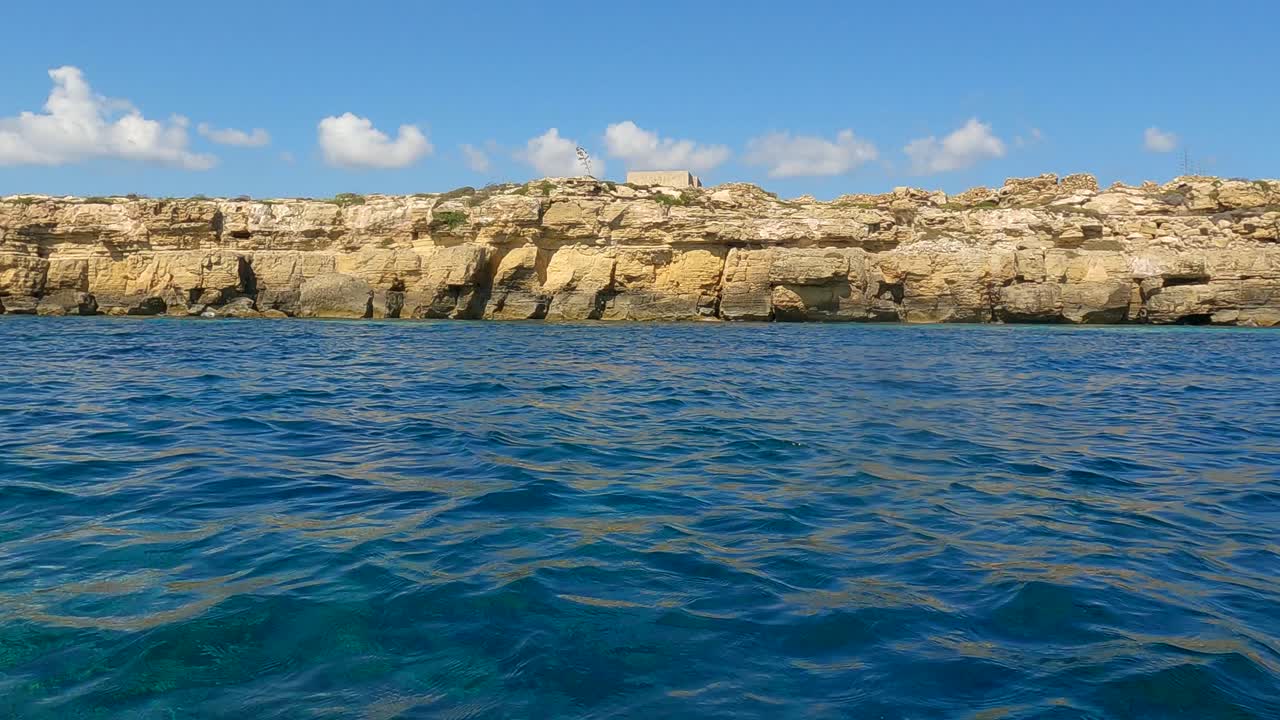 Vista dal basso, a livello del mare, da una barca a vela della costa dell'isola di Favignana in Sicilia, Italia.