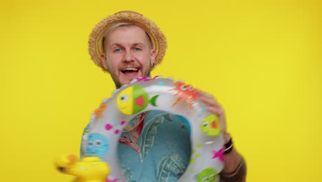 traveler tourist adult man dancing fooling with swimming ring and duck toy travel on weekends