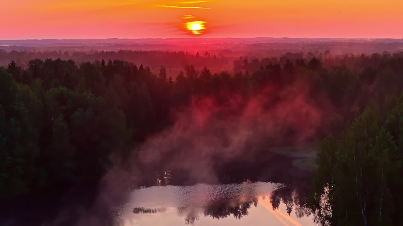 Colorful autumn sunset over a misty forest, stunning aerial landscape with river and field