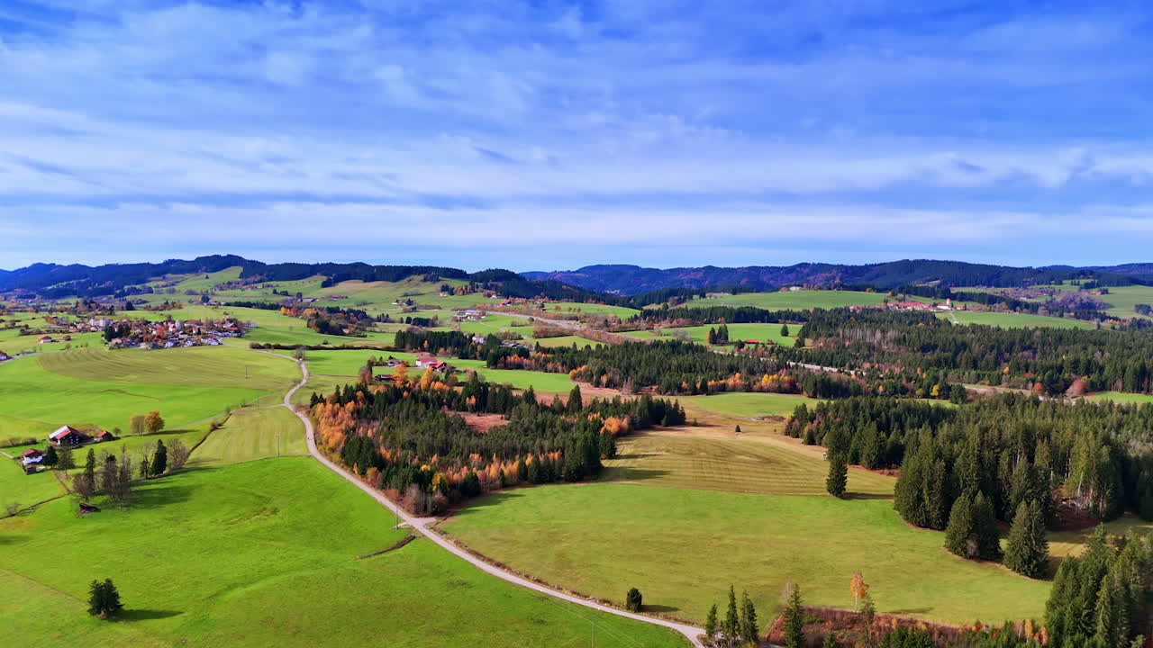 Flight over the picturesque meadows and fir-tree woods with some rural areas. Wonderful scenery of nature Weitnau, a municipality in the rural district in Bavaria, Germany