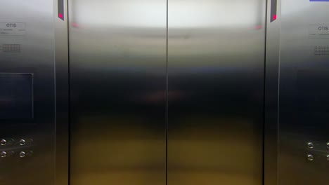 closing elevator doors in a modern office building