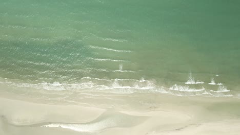 Aerial-birds-eye-view-down-shot-of-pristine-tropical-beach-in-Thailand