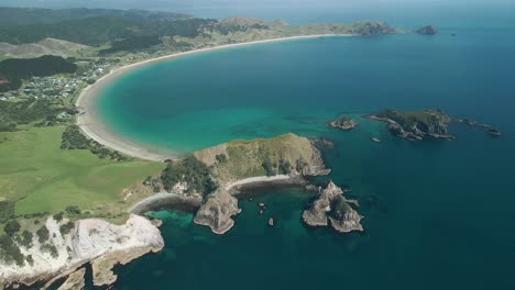 drone flight over optio bay, coromandel peninsula at midday in summer