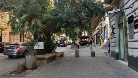 tourists walking through naples, enjoying cafes and scenery