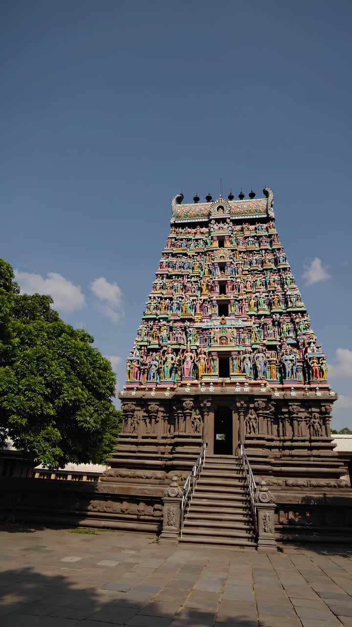 A vibrant, colorful temple captured from a low-angle, showcasing intricate details against a clear