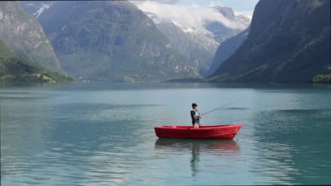 Woman-on-the-boat-catches-a-fish-on-spinning-in-Norway.