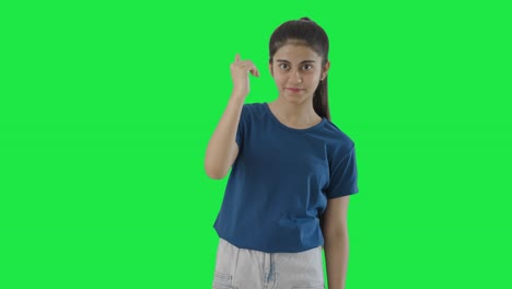 Indian-teenage-girl-pointing-and-calling-someone-Green-screen