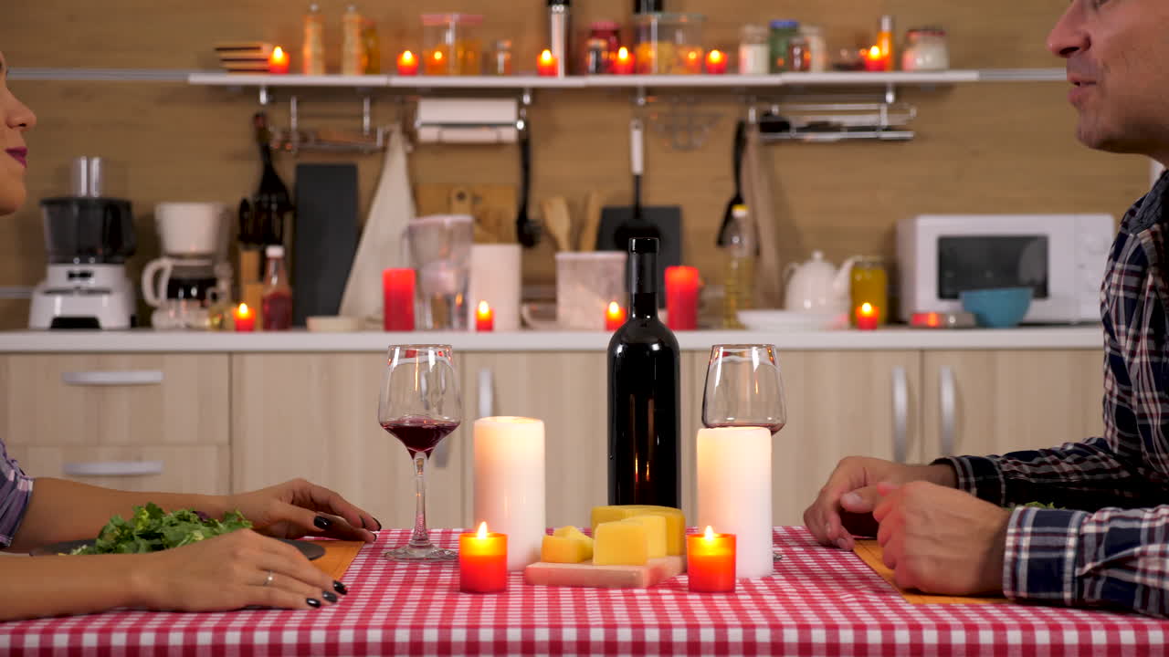 Couple having romantic dinner with wine and candles