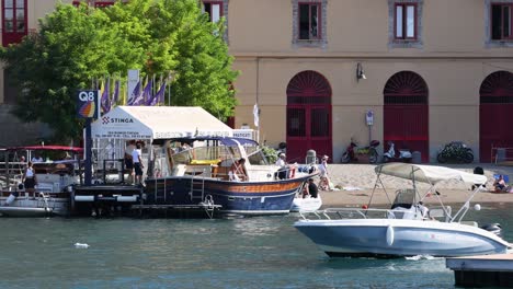 boats docking and people interacting at sorrento harbor