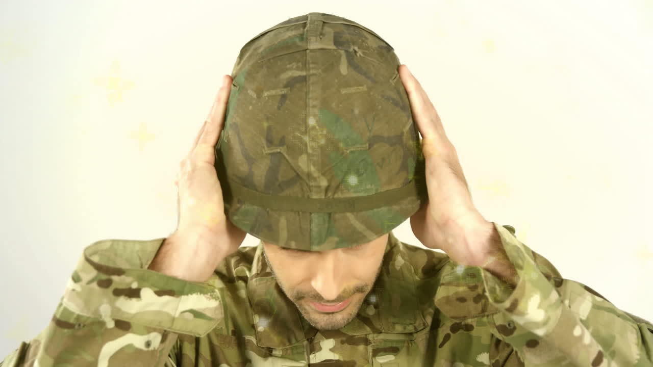 Adjusting helmet with both hands, person in camouflage uniform outdoors