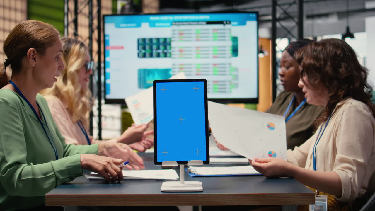 Vertical Video Businesswomen use a copy space display and charts to pitch career vision