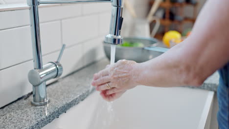 washing hands in kitchen sink