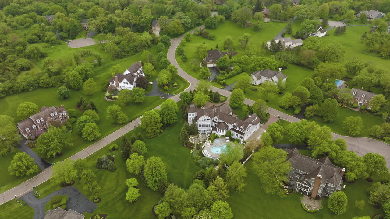 Beautiful private mansions located in the green suburb. Lovely houses connected with roads and paths and surrounded by greenery. Top view.