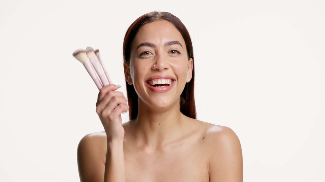 Beautiful Woman with Makeup Brushes