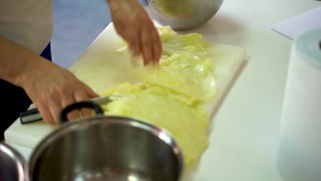 Chef-Cutting-Thick-Part-Of-Cabbage-Leaves---Stuffed-Cabbage-Roll-Preparation---close-up