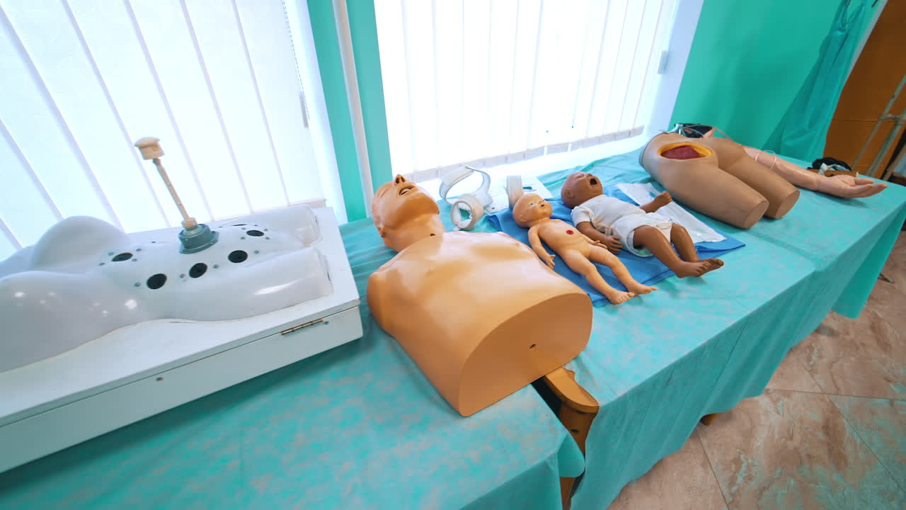 Mannequins on the table for medical training. Plastic dolls and parts of patient's body models for teaching practice in the university.