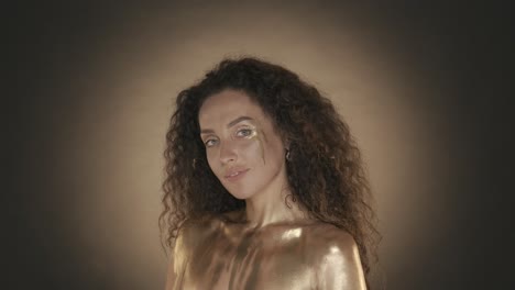 woman with gold body paint and makeup