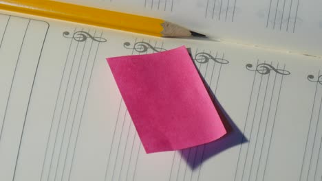 pencil on music note book with post it paper