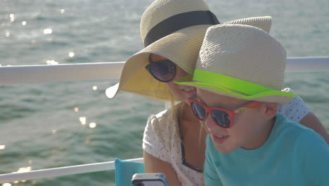 Child-and-mother-making-selfie-on-the-ship