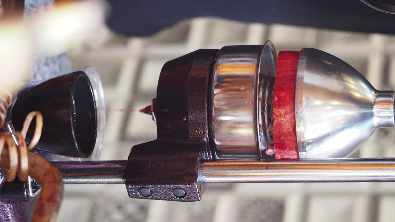 Hand-cranked Fruit Juicer in Action