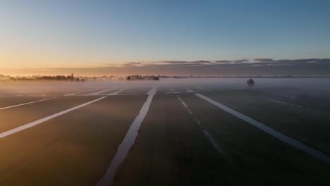 sunrise over dutch polders with fog