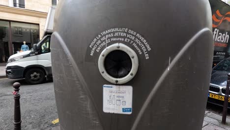 sequence showing a recycling bin in a busy city.