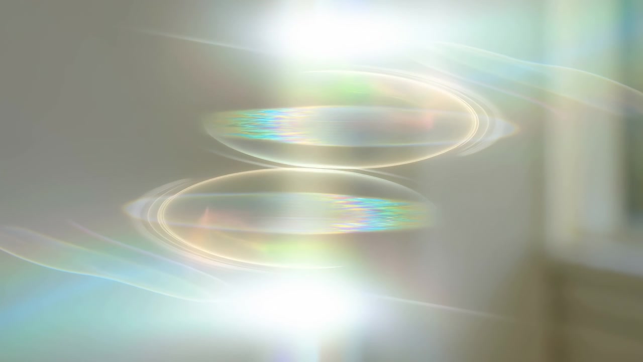 Iridescent Light Rings Floating In Studio, Soft Bokeh And Prism Flares Creating Calming Ambient Shimmer,