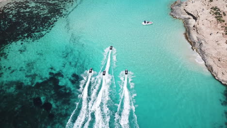 jet skiing on crystal clear turquoise water. an exiting and fun travel experience in mediterranean paradise.
