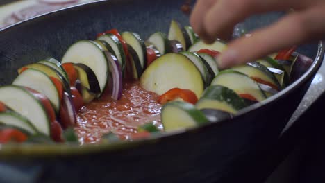 vegetarian dish being prepared by a person