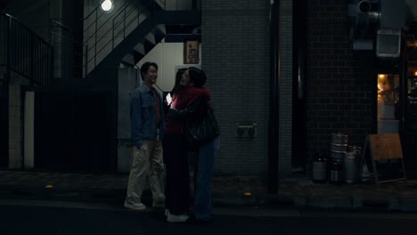 friends enjoying a night out in a japanese city street