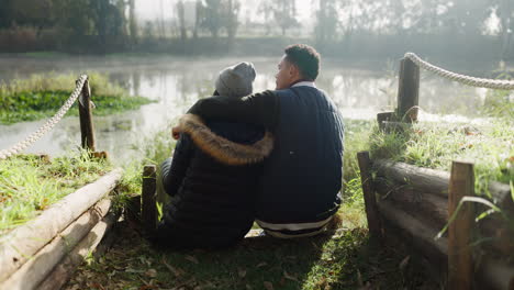 hiking, hug and couple back by a lake in nature