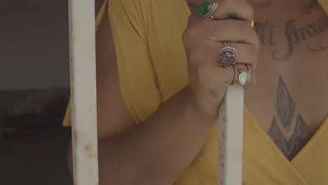 Slow-motion-close-up-clip-of-a-tattooed-African-American-model-holding-the-bars-of-a-jail-cell