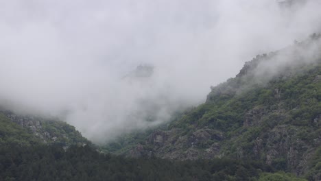 Time-lapse-of-a-dark-misty-mountain-hills-in-spring