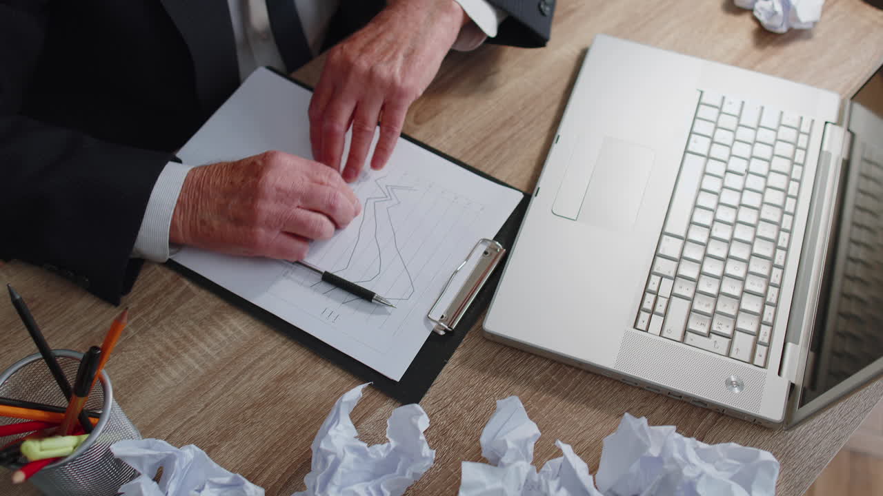 Tired sleepy overworked senior business man falling asleep sit at home office desk with laptop