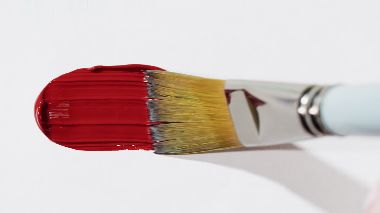 Close-up of a paintbrush with red paint