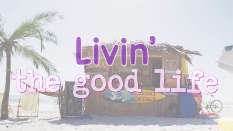 animation of the words livin' the good life written in purple and white over beach surf rental hut