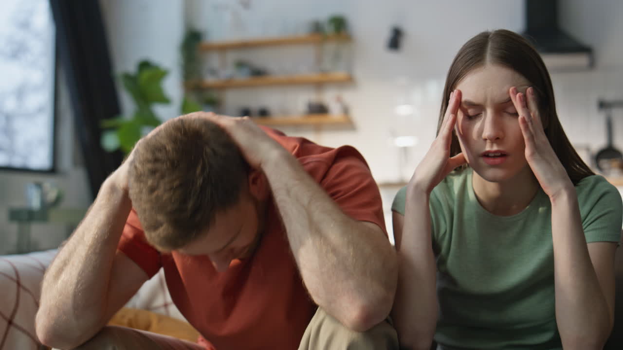 Emotional couple cheering sport game at home sofa closeup. Tensed husband wife