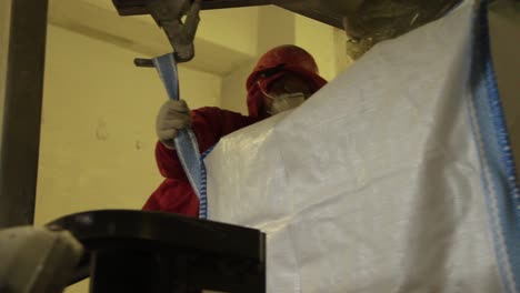 worker handling big bag in industrial setting