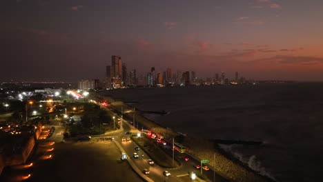 Aerial-view-over-the-Avenida-San-Martín,-towards-the-Bocagrande-cityscape,-dusk-in-Cartagena,-Colombia