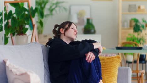 sad teenager using smartphone, victim of online hate
