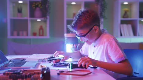 excited little boy looking intently at electronic card.