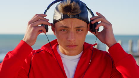 Teen-with-headphones,-beach-and-travel-with-music