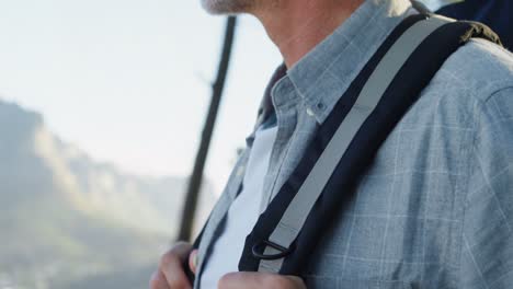 senior man standing with backpack at countryside 4k