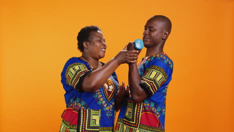 smiling woman encouraging her husband to lift weight