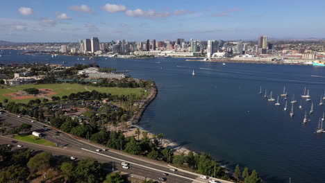 Drone-Flying-Over-Vehicles-Driving-On-Coronado-Bridge-Towards-San-Diego-Skyline-Beyond-San-Diego-Bay-In-California,-USA